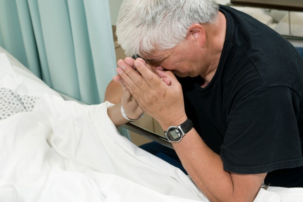 Grief - grieving local man at bedside